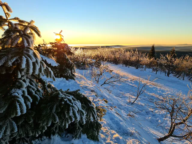 Sunset over snow-covered hills